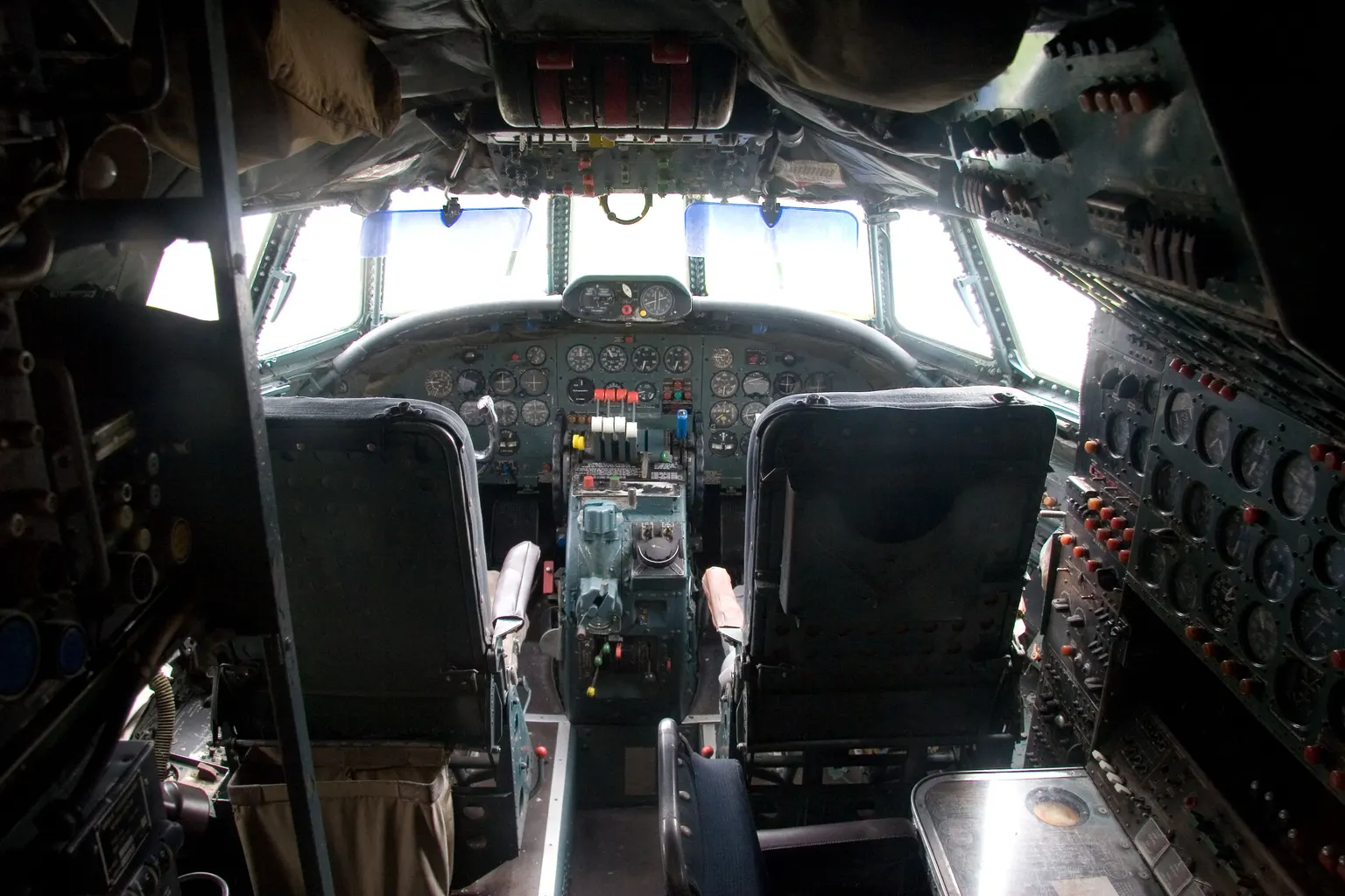The flight deck of a preserved Lockheed L-1049 Super Constellation: two seats facing a panel of round dials.