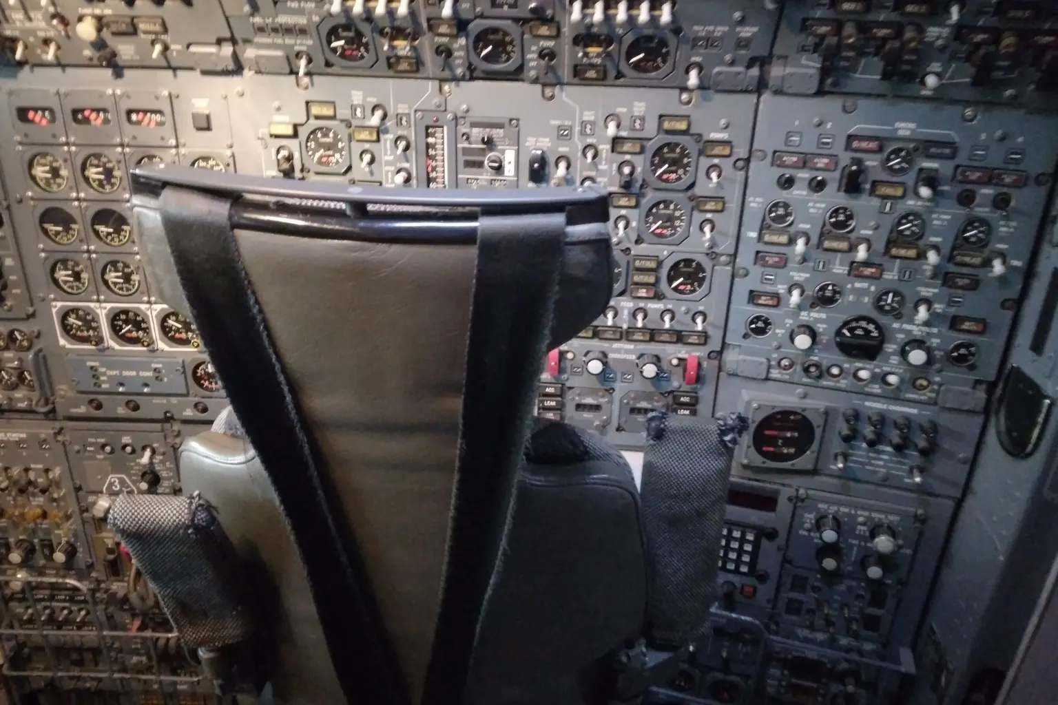 Concorde’s flight engineer’s station, preserved at Manchester: a wall of dials, gauges and switches behind an empty seat.