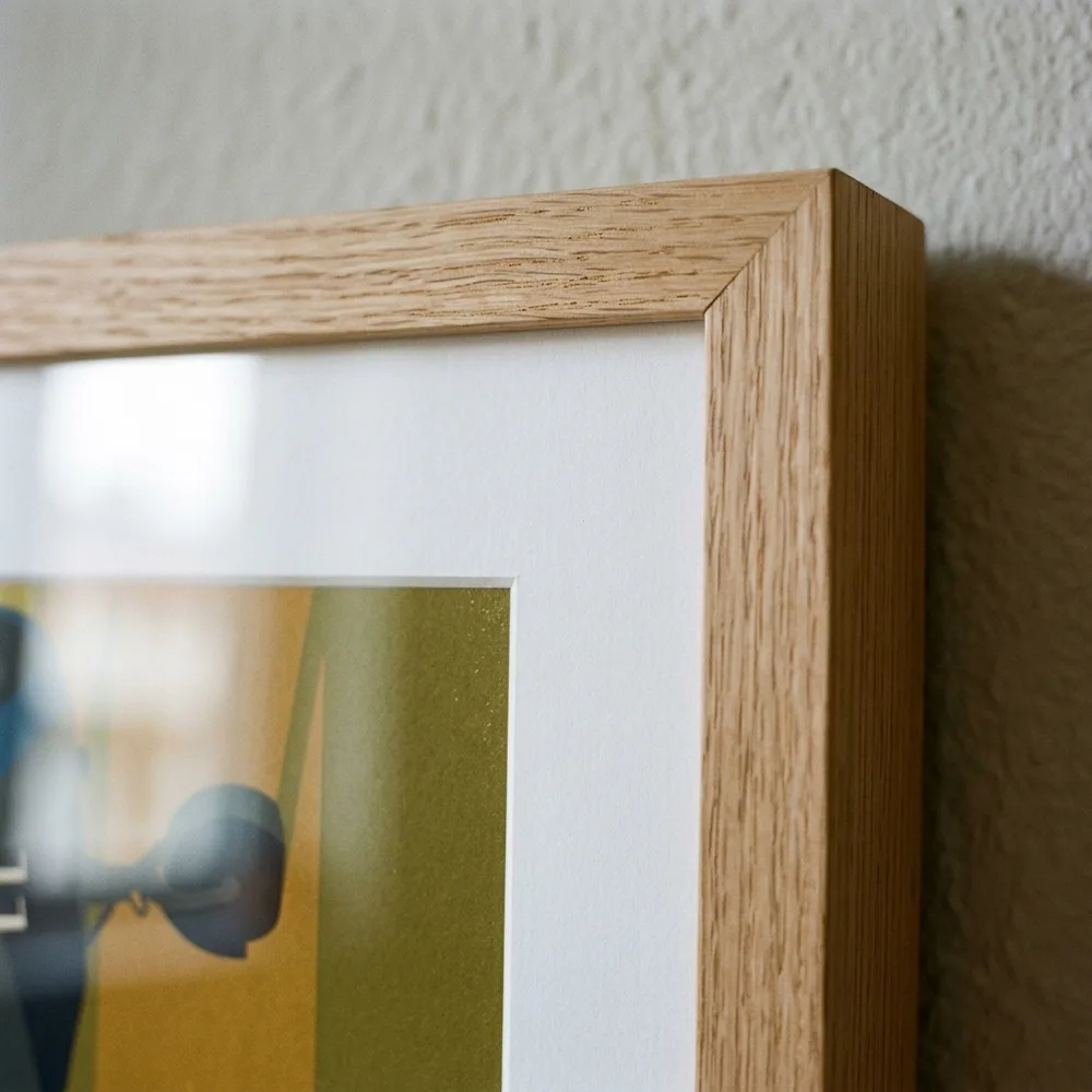 Mitred corner of a natural oak frame with white mount